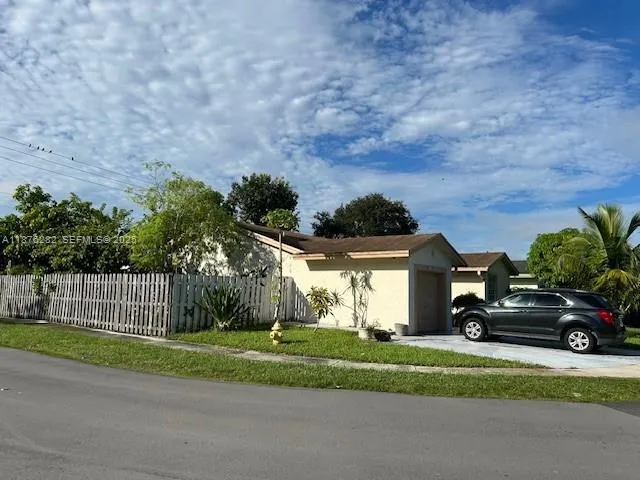 a view of a car parked in front of a brick house