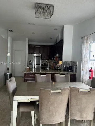 a view of kitchen with dining table and chairs
