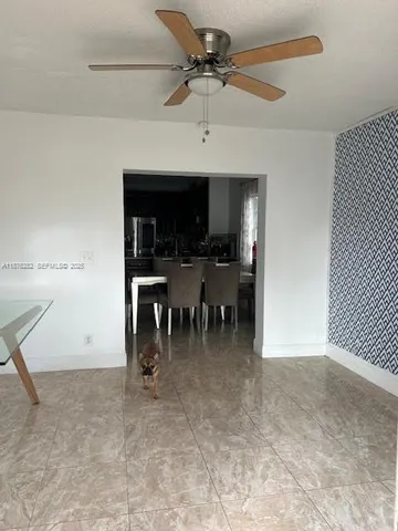 a view of a livingroom with furniture and a ceiling fan