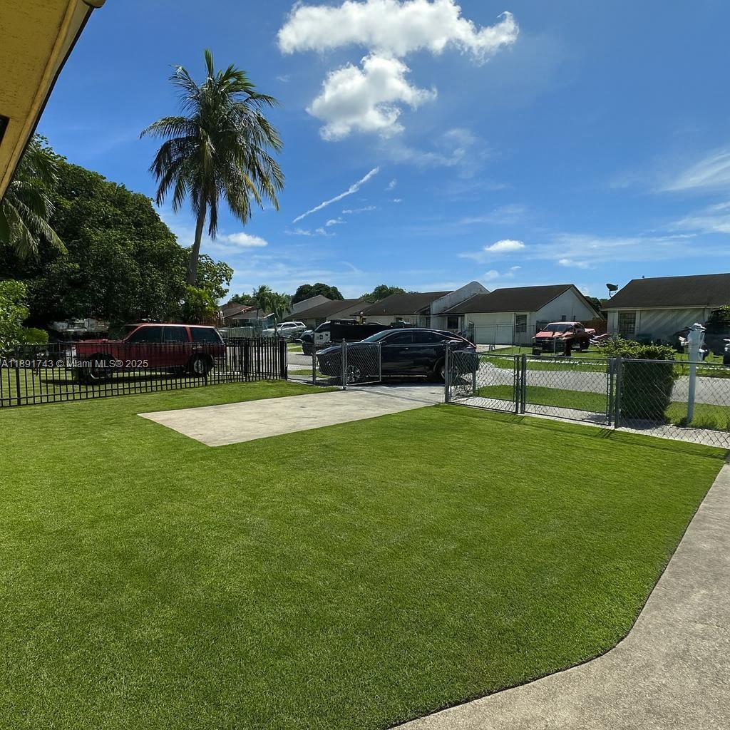 3611 Northwest 194th Terrace Miami Gardens, FL 33056 - Photo 2 of 15 a view of a swimming pool with a garden