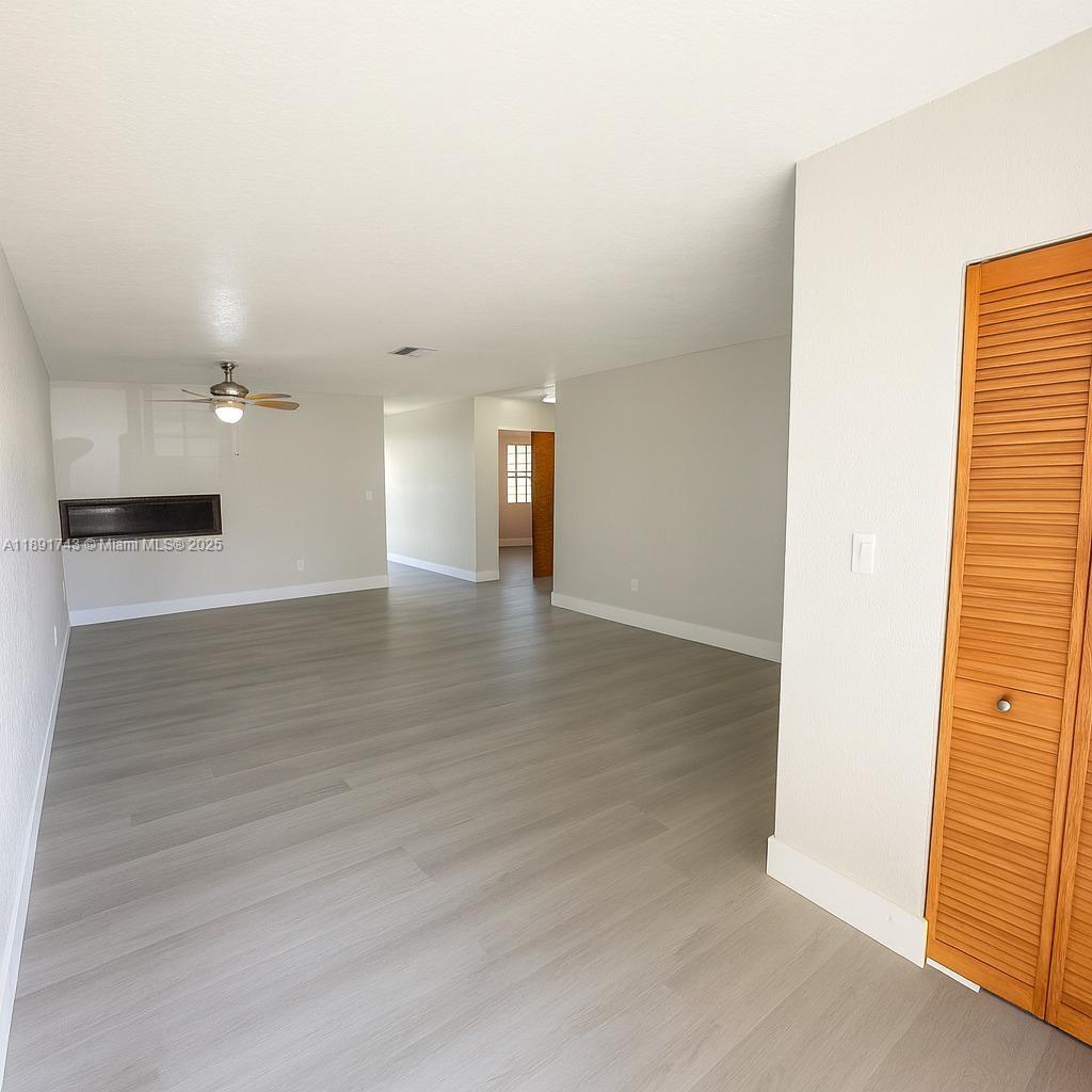 3611 Northwest 194th Terrace Miami Gardens, FL 33056 - Photo 3 of 15 an empty room with wooden floor and windows