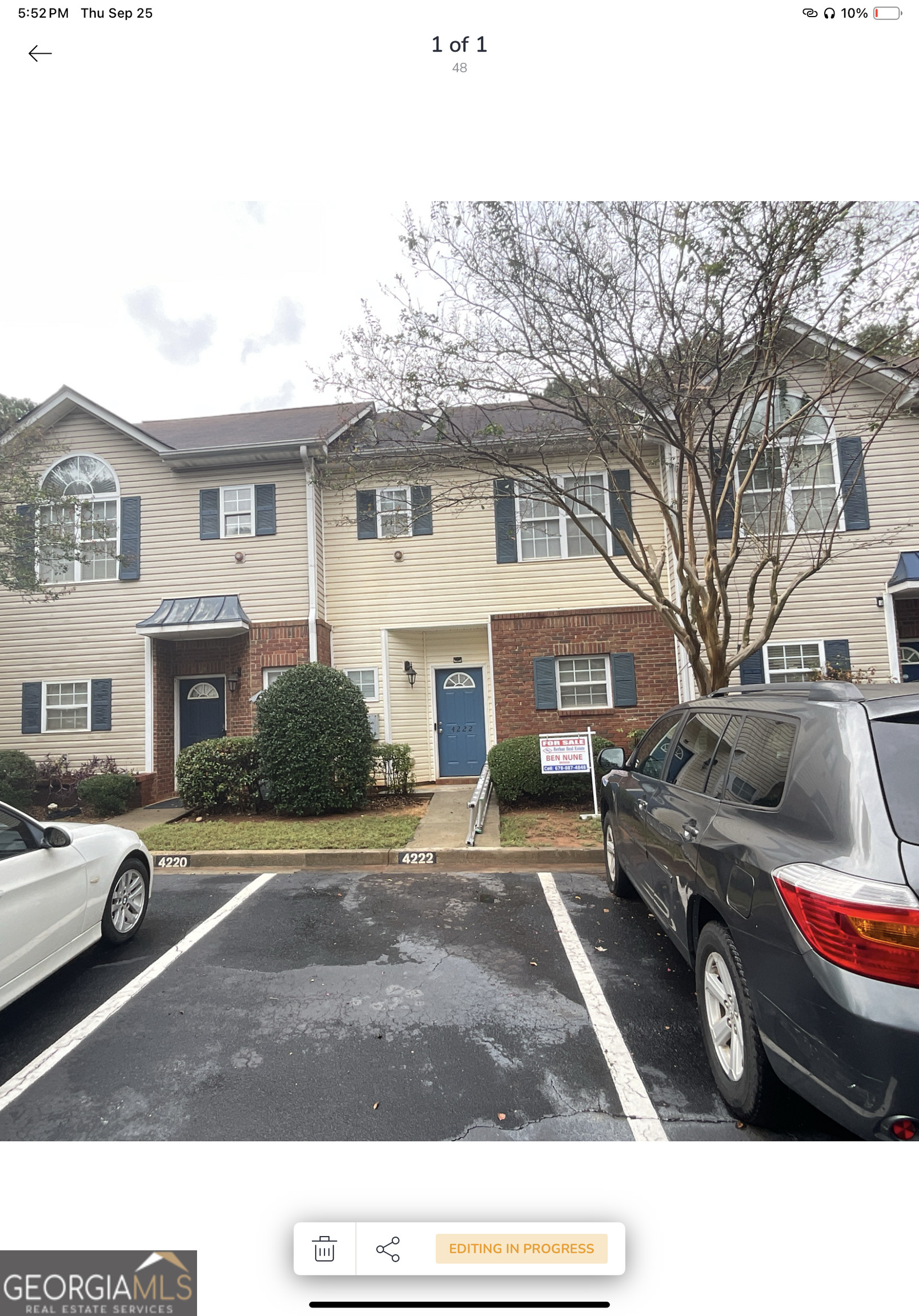 a view of a car parked in front of a white house