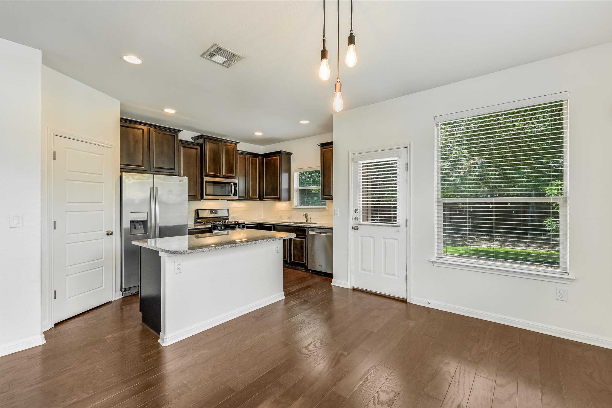 7709 Menchaca Road, Unit 1 Austin, TX 78745 - Photo 28 of 29 Desirable open floor plan with kitchen open to dining and living. Granite countertops, stainless steel appliances, pantry, center island with breakfast bar seating, and hardwood floors.