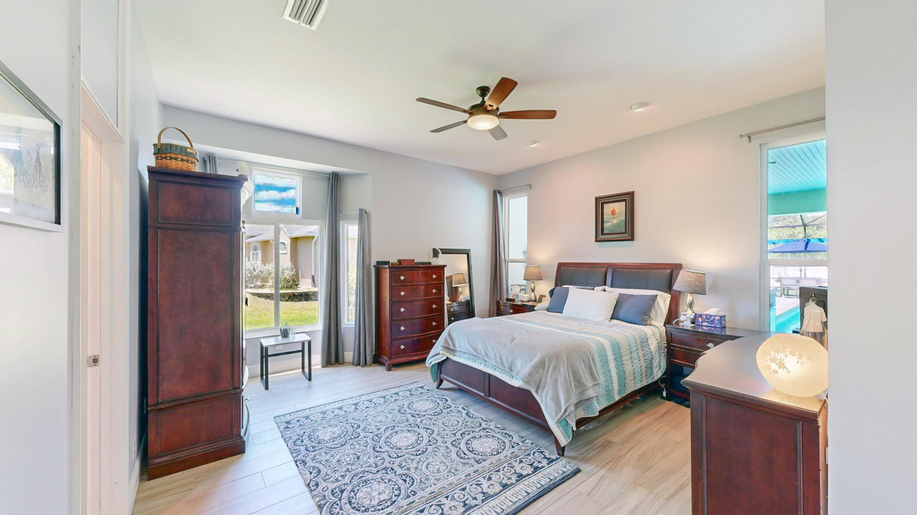 4490 Canard Road Melbourne, FL 32934 - Photo 24 of 52 a bedroom with a bed and a chandelier