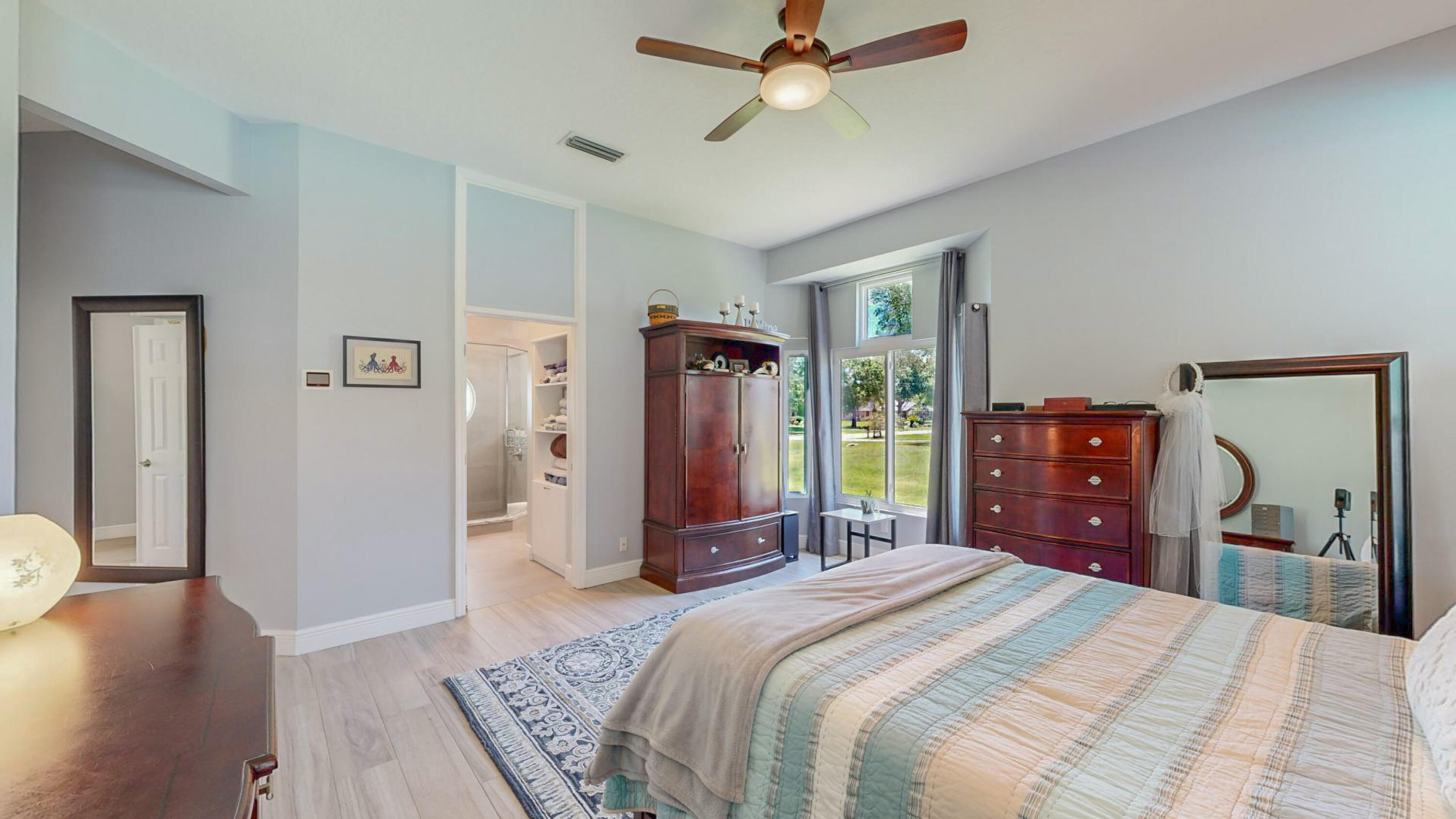 4490 Canard Road Melbourne, FL 32934 - Photo 25 of 52 a bedroom with a bed and a chandelier