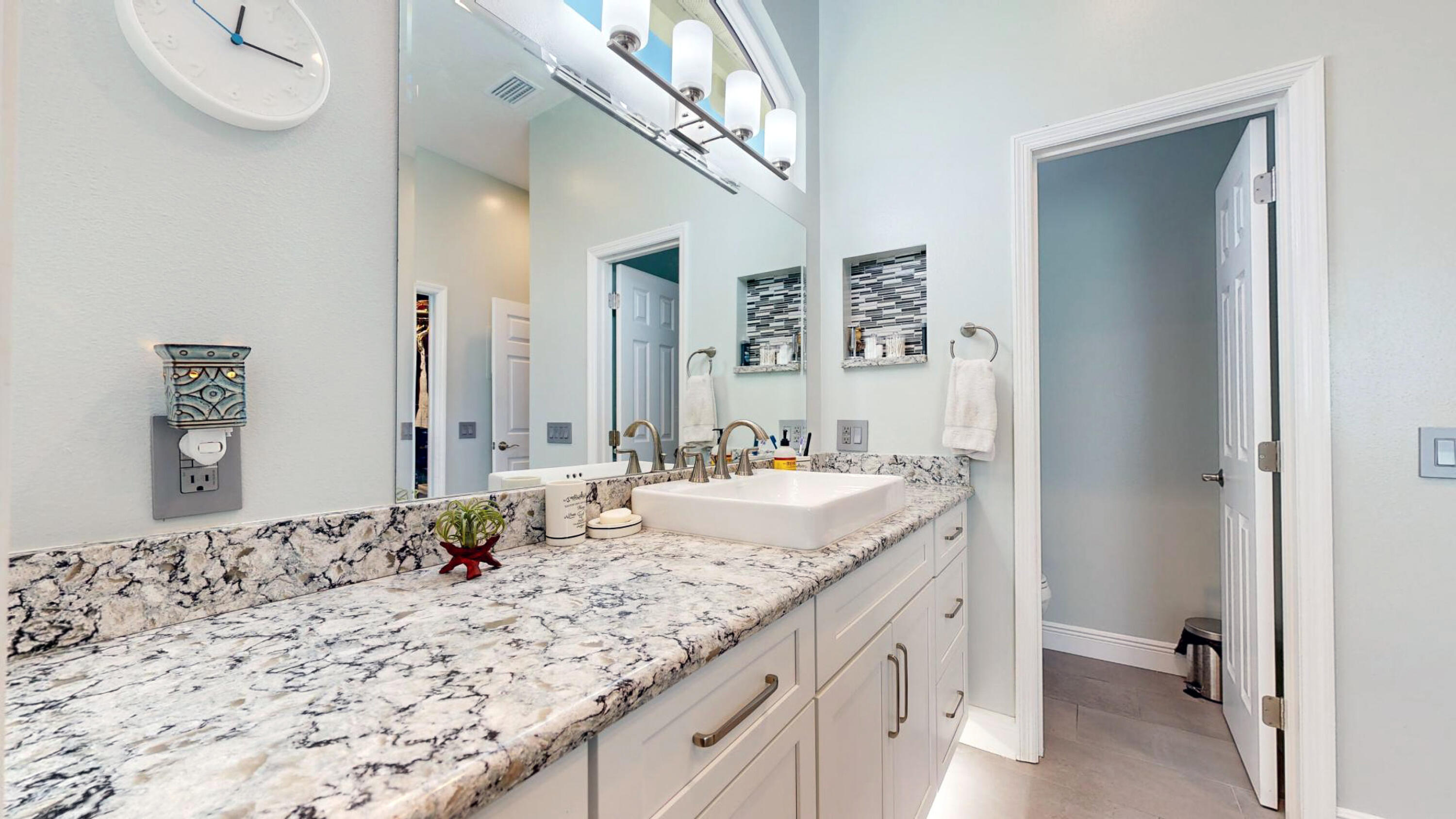 4490 Canard Road Melbourne, FL 32934 - Photo 28 of 52 a bathroom with a granite countertop sink and a mirror