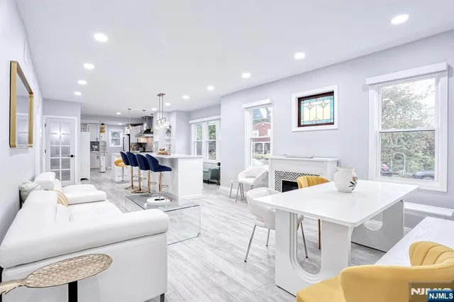 a view of a dining room with furniture and a large window