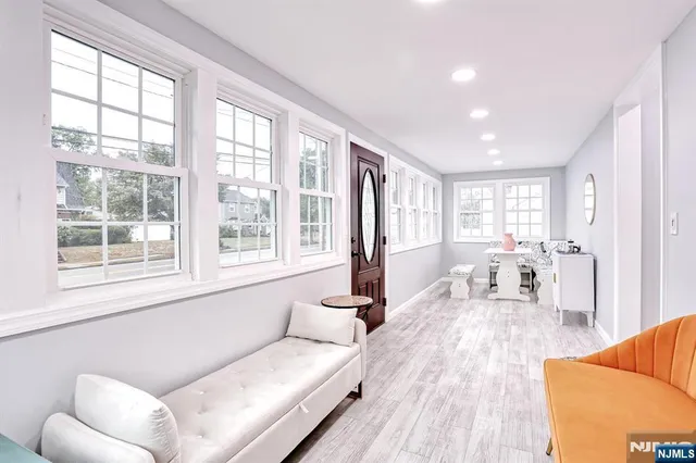 a living room with furniture and large windows