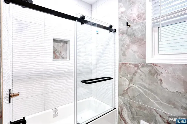 a bathroom with a shower and a mirror