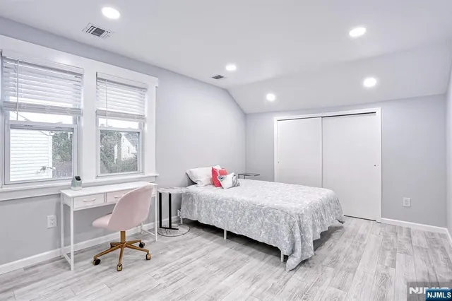 a bedroom with a bed and a table in it