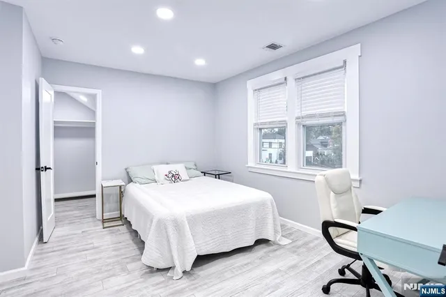 a bedroom with a bed and a desk