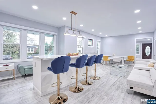 a living room with furniture a window and kitchen view