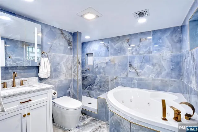 a bathroom with a white bath tub a toilet and a sink