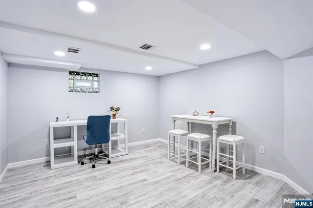 a work room with wooden floor and furniture