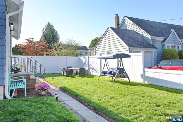 a view of a backyard with a table and chairs