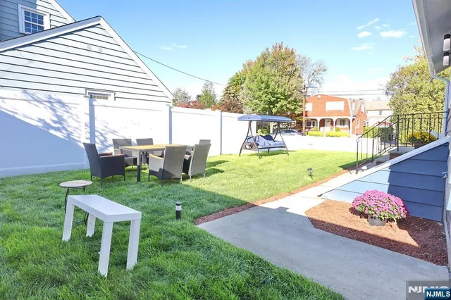 a view of a backyard with table and chairs