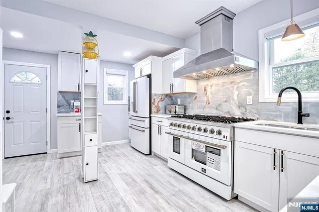 a kitchen with a stove a sink and a refrigerator