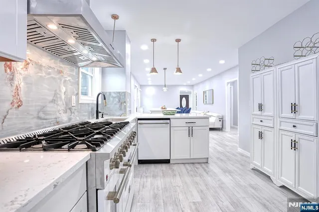 a kitchen with cabinets and stove