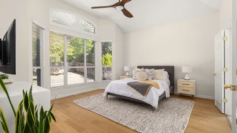 a bedroom with a bed and flat screen tv