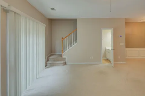 an empty room with a window and a ceiling fan