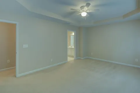 an empty room with a chandelier fan