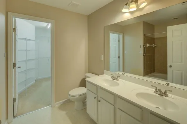 a bathroom with a tub sink shower and mirror