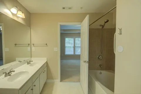 a bathroom with a sink mirror and vanity