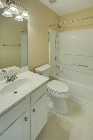 an empty room with a window and mirror