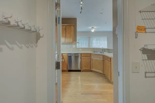 a view of a kitchen with white cabinets