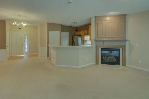 a view of an empty room and fire place