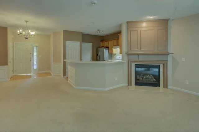 a view of an empty room and fire place