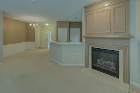 a view of an empty room with a fireplace