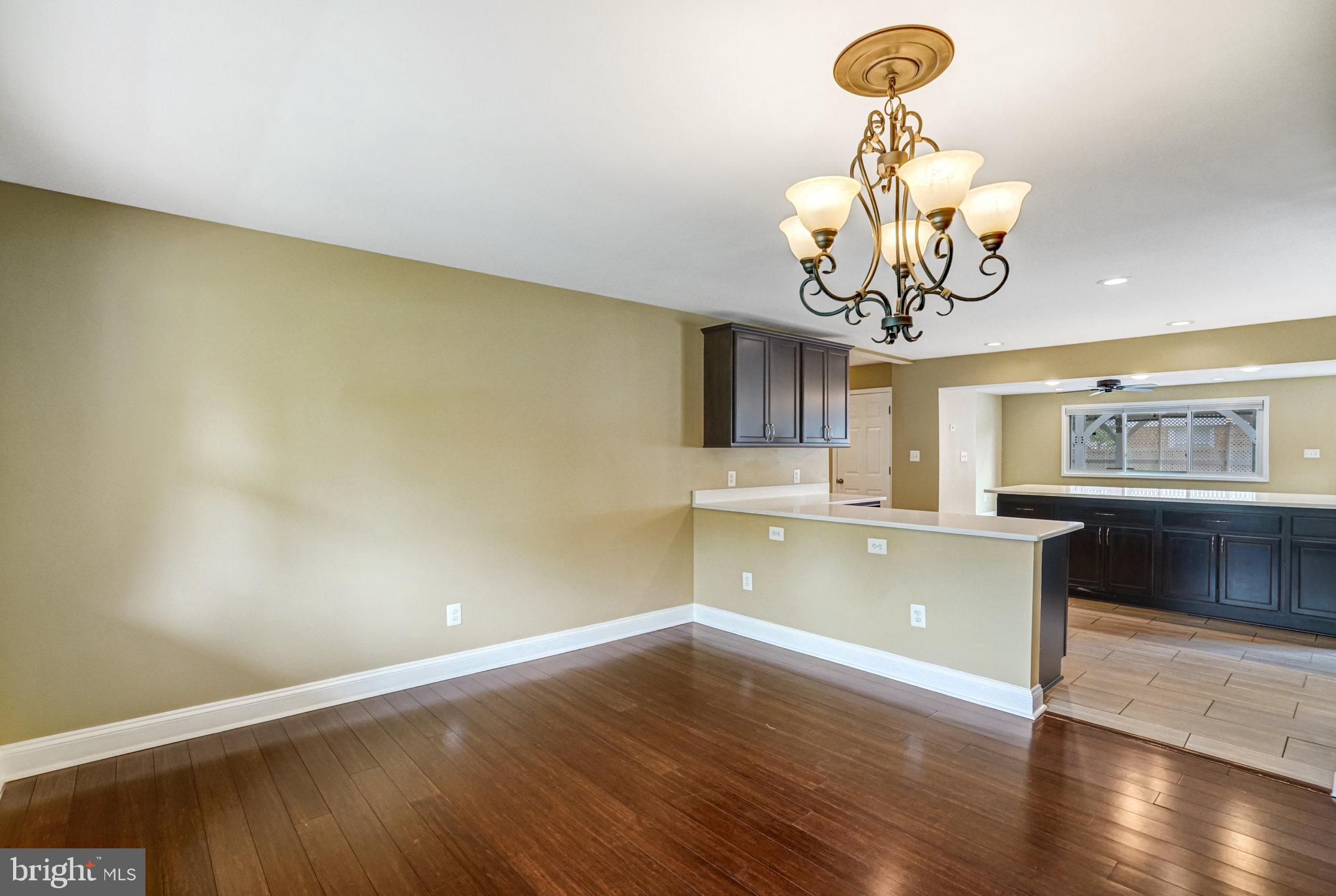 5227 Cather Road Springfield, VA 22151 - Photo 13 of 72 a view of a room with wooden floor and a chandelier