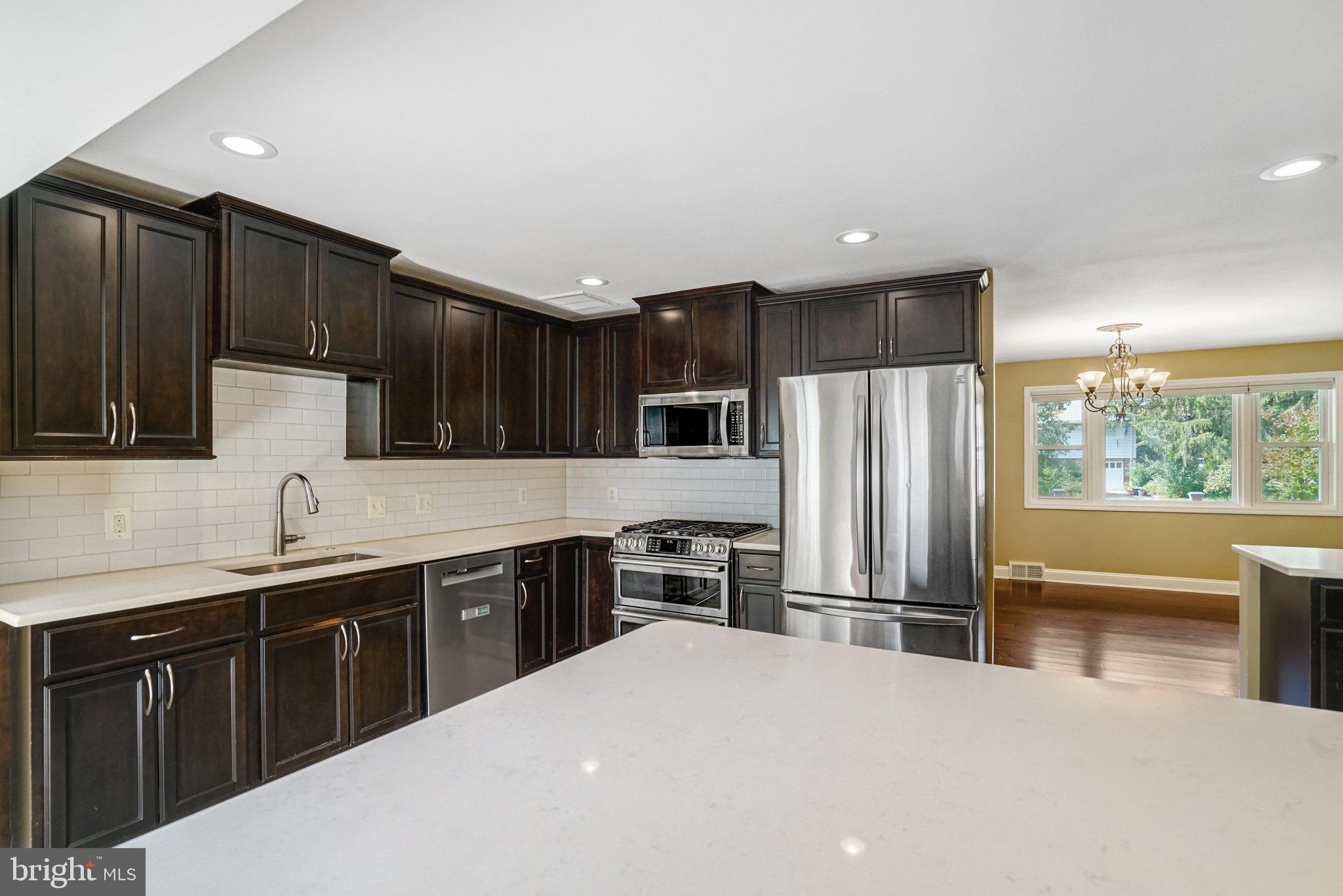 5227 Cather Road Springfield, VA 22151 - Photo 17 of 72 a kitchen with stainless steel appliances a sink stove and refrigerator