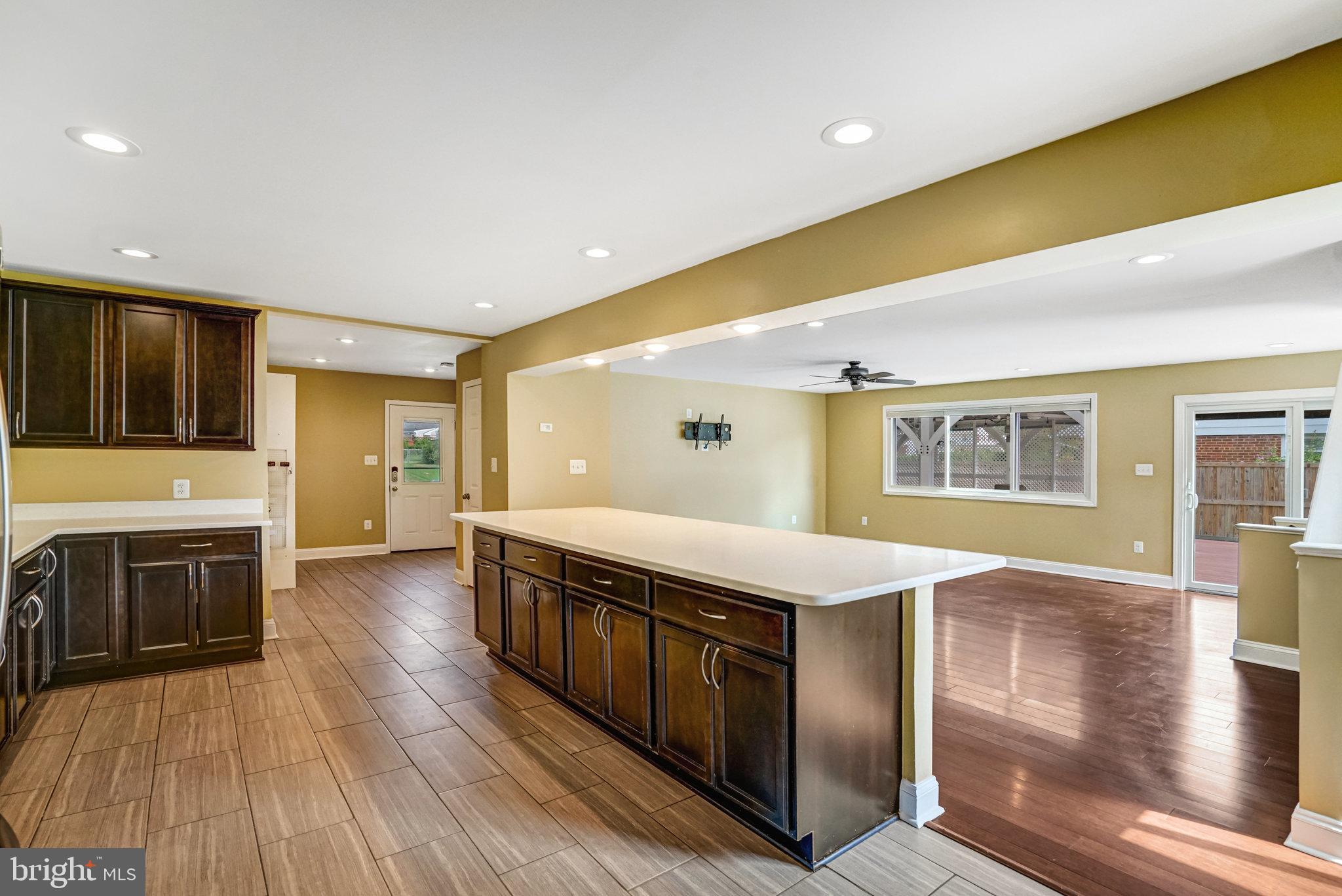 5227 Cather Road Springfield, VA 22151 - Photo 20 of 72 a spacious bathroom with stainless steel appliances granite countertop a large kitchen counter top a stove and a wooden floors