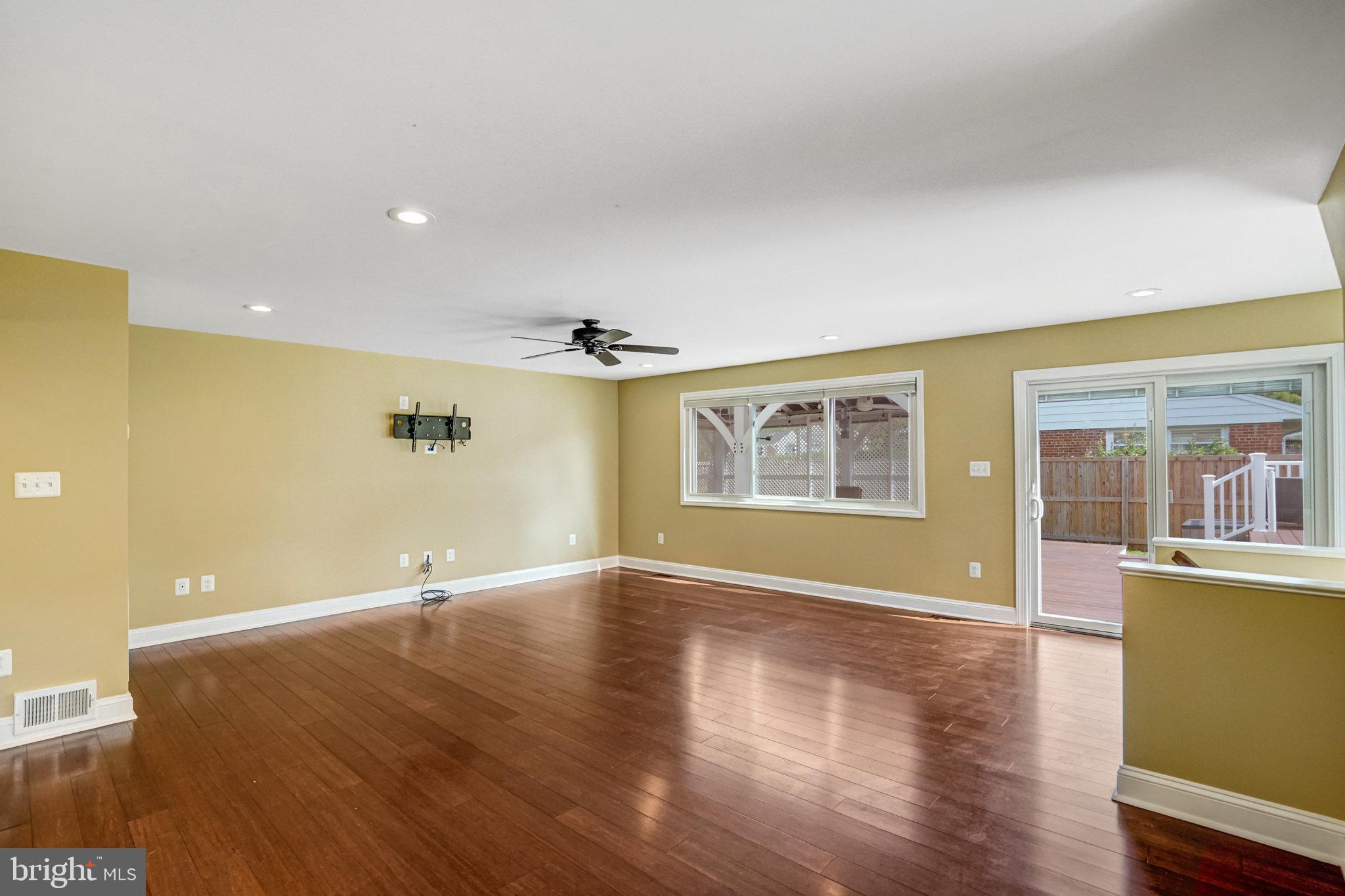 5227 Cather Road Springfield, VA 22151 - Photo 24 of 72 an empty room with wooden floor and windows