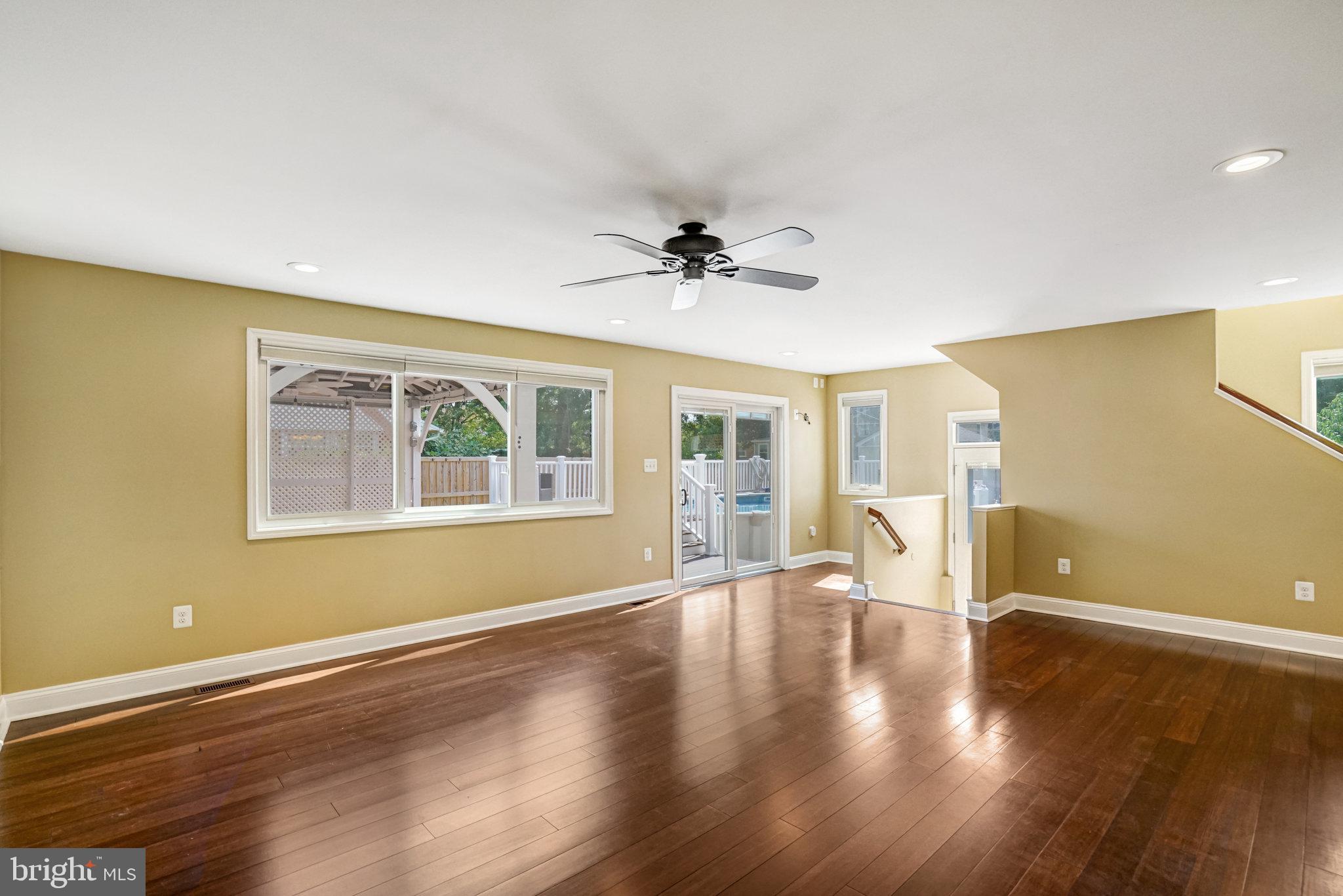 5227 Cather Road Springfield, VA 22151 - Photo 25 of 72 a view of an empty room with a window and wooden floor