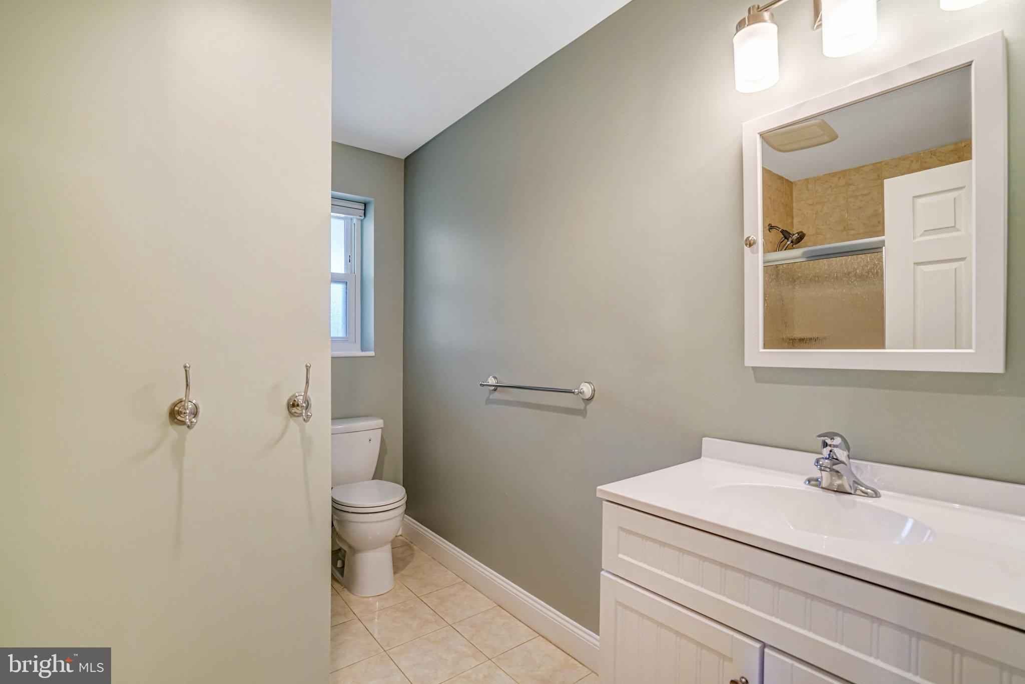5227 Cather Road Springfield, VA 22151 - Photo 3 of 72 a bathroom with a sink a toilet and a mirror