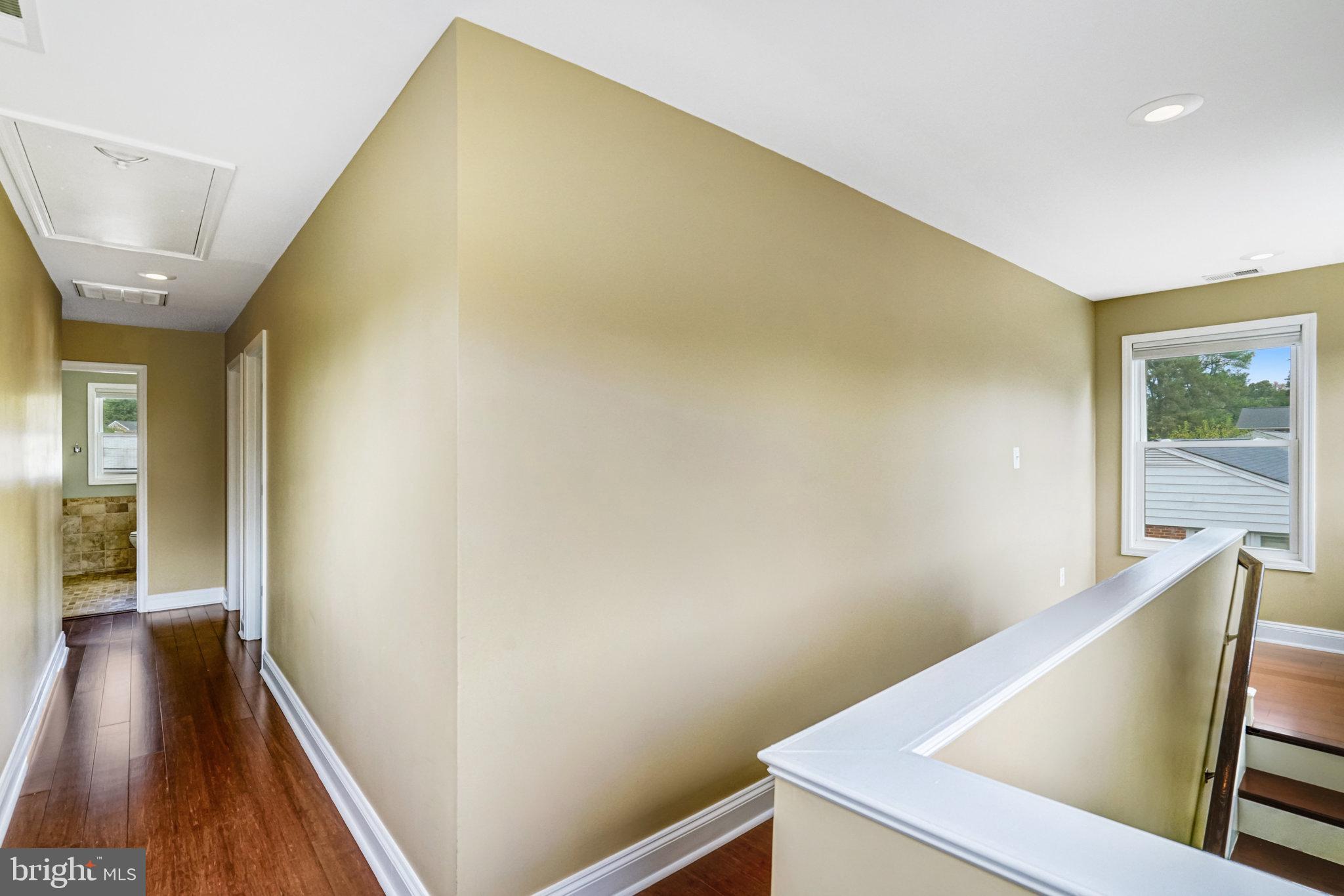 5227 Cather Road Springfield, VA 22151 - Photo 31 of 72 a view of a hallway with wooden floor and stairs