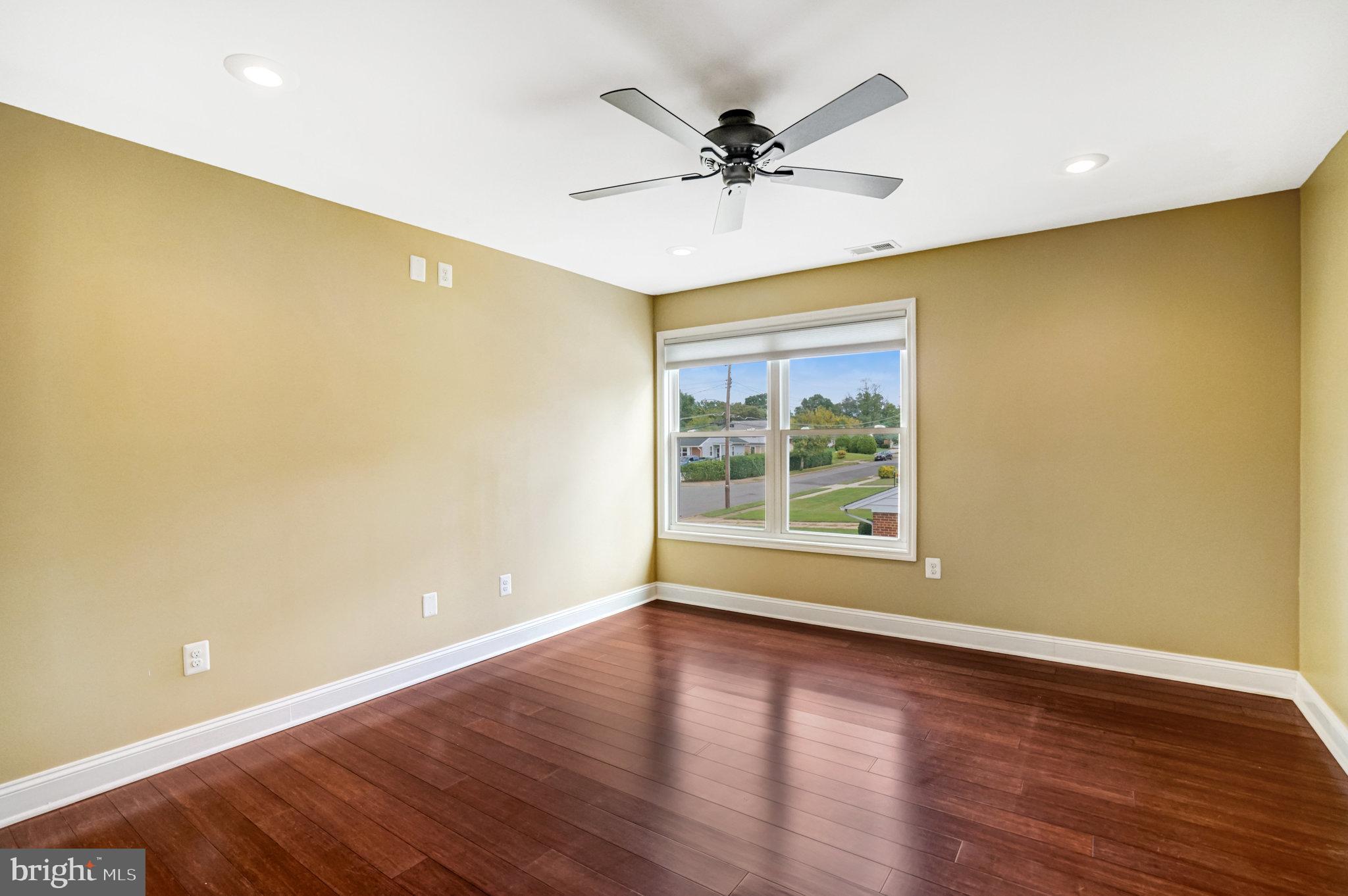 5227 Cather Road Springfield, VA 22151 - Photo 33 of 72 a view of an empty room with wooden floor and a window