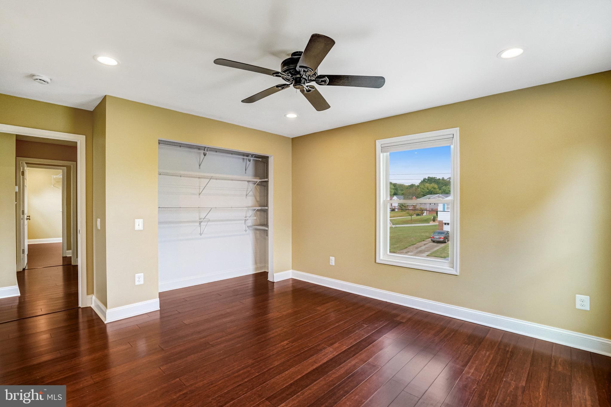 5227 Cather Road Springfield, VA 22151 - Photo 34 of 72 a view of an empty room with wooden floor and a window