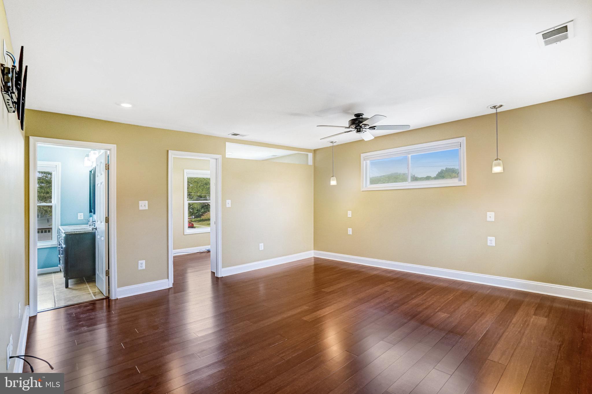5227 Cather Road Springfield, VA 22151 - Photo 39 of 72 an empty room with wooden floor and windows