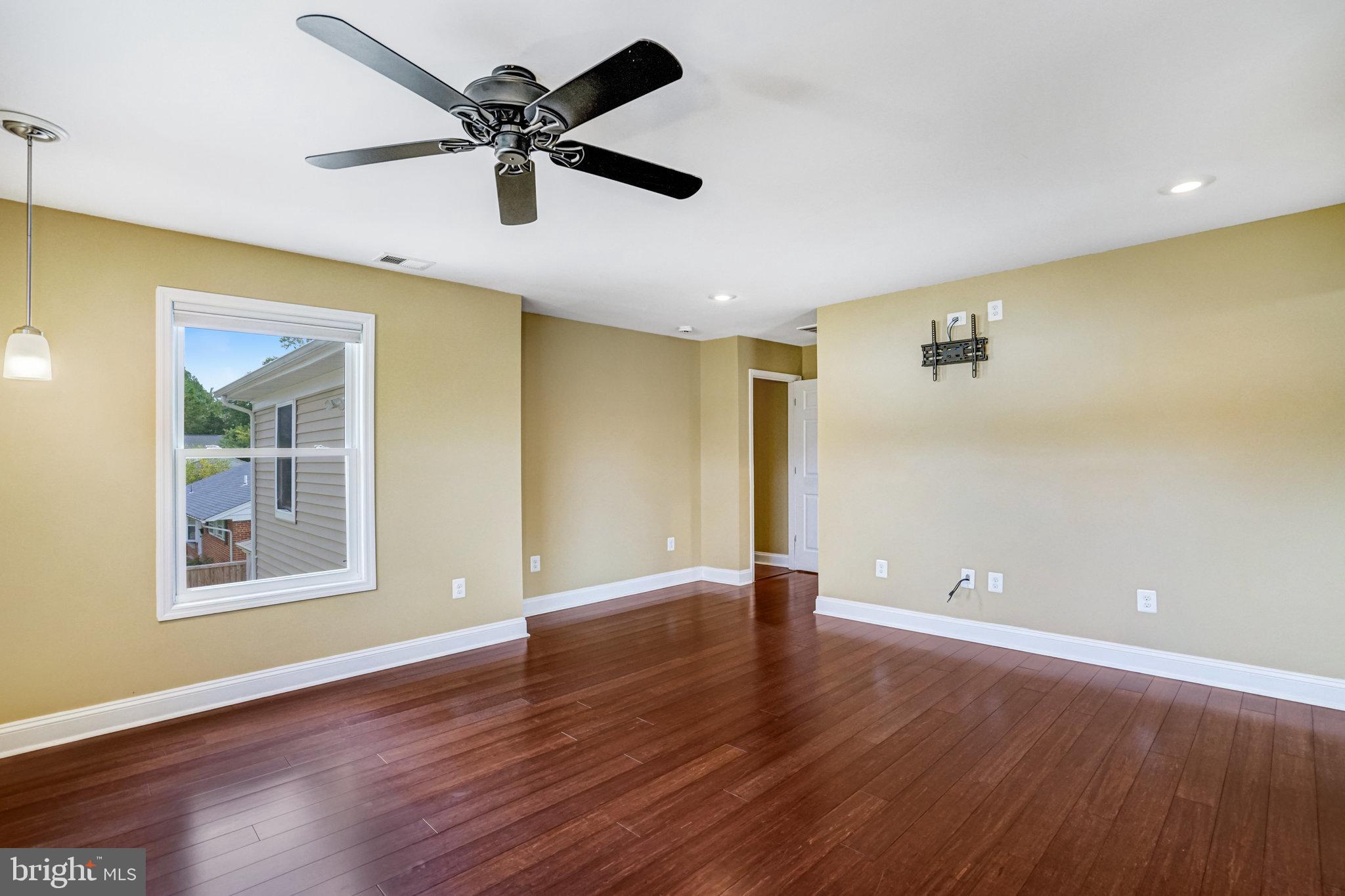 5227 Cather Road Springfield, VA 22151 - Photo 40 of 72 a view of an empty room with window and wooden floor