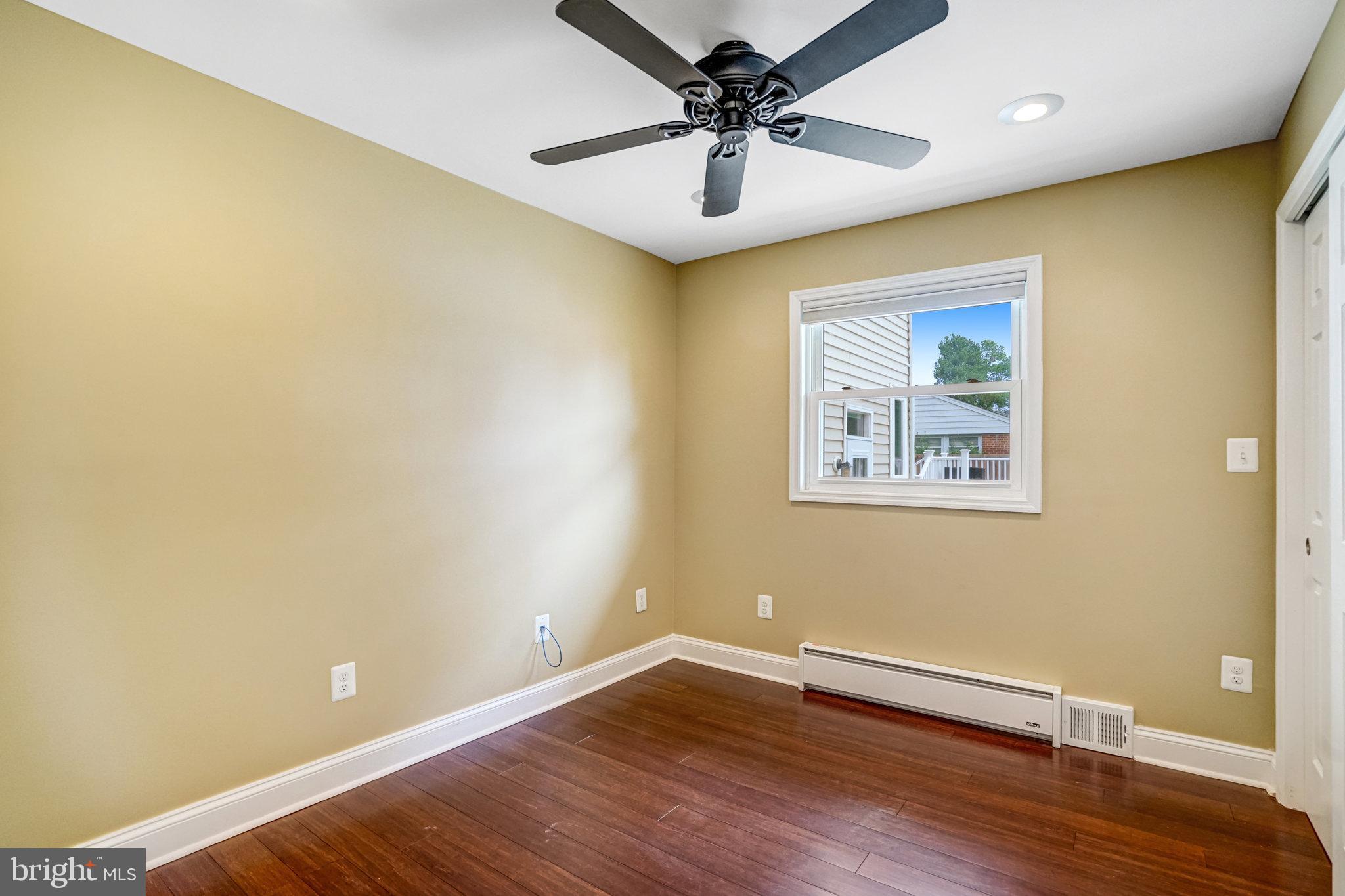 5227 Cather Road Springfield, VA 22151 - Photo 4 of 72 a view of an empty room with wooden floor and a ceiling fan