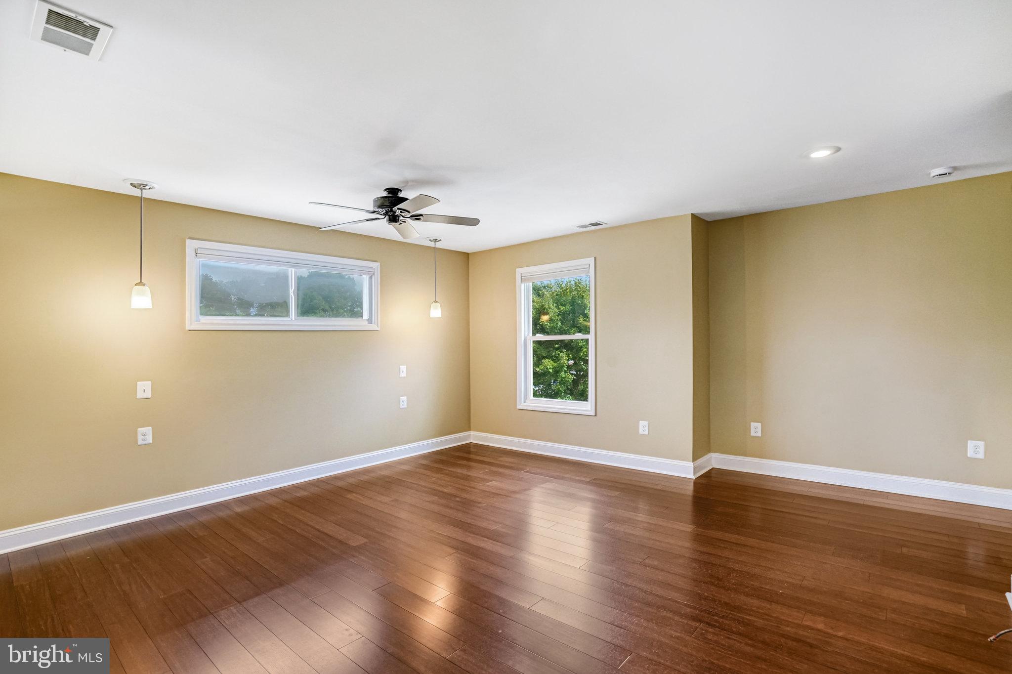 5227 Cather Road Springfield, VA 22151 - Photo 41 of 72 a view of an empty room with wooden floor and a window