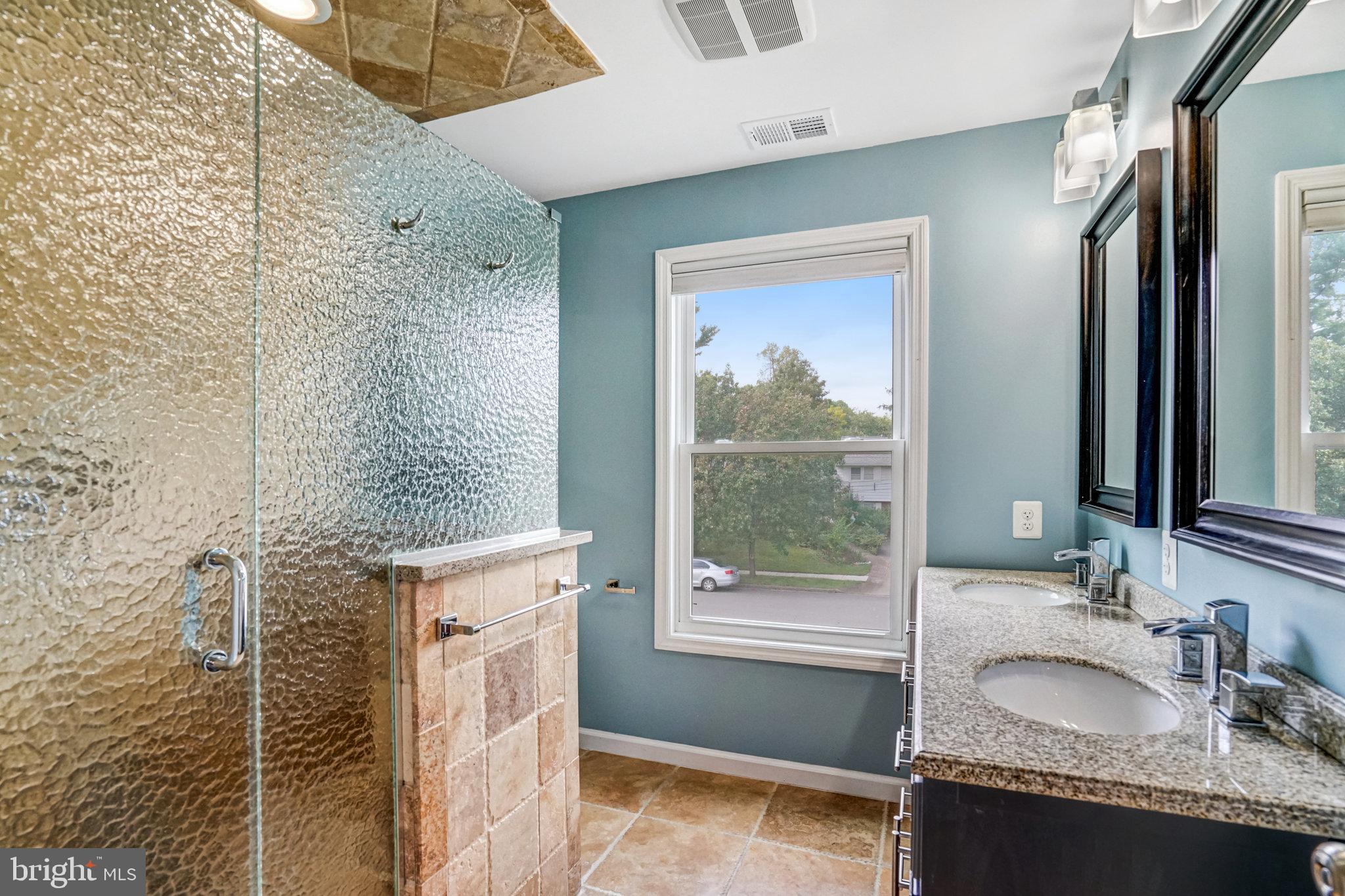 5227 Cather Road Springfield, VA 22151 - Photo 46 of 72 a en suite bathroom with a granite countertop sink and a mirror