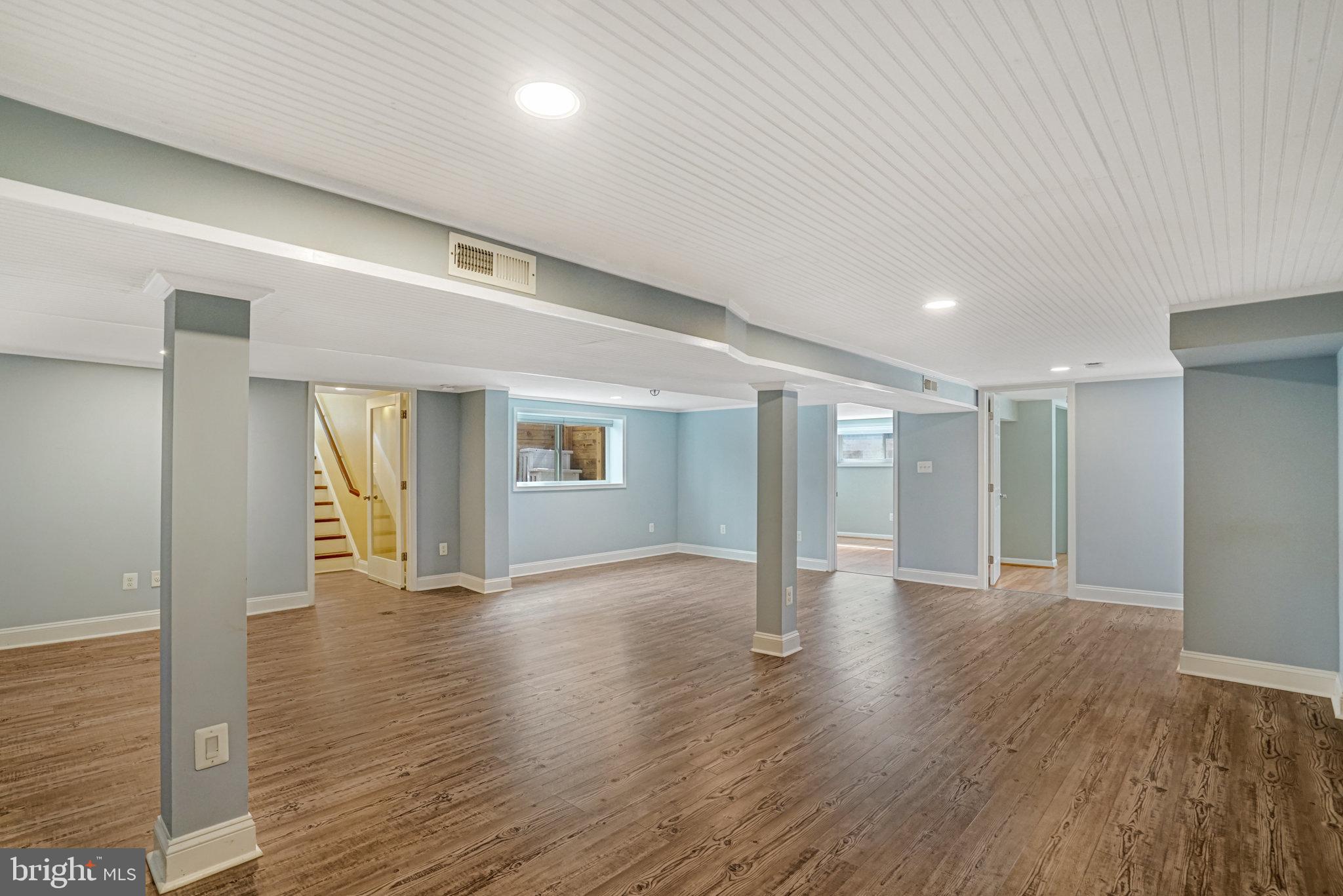 5227 Cather Road Springfield, VA 22151 - Photo 49 of 72 a view of an empty room with wooden floor and a window