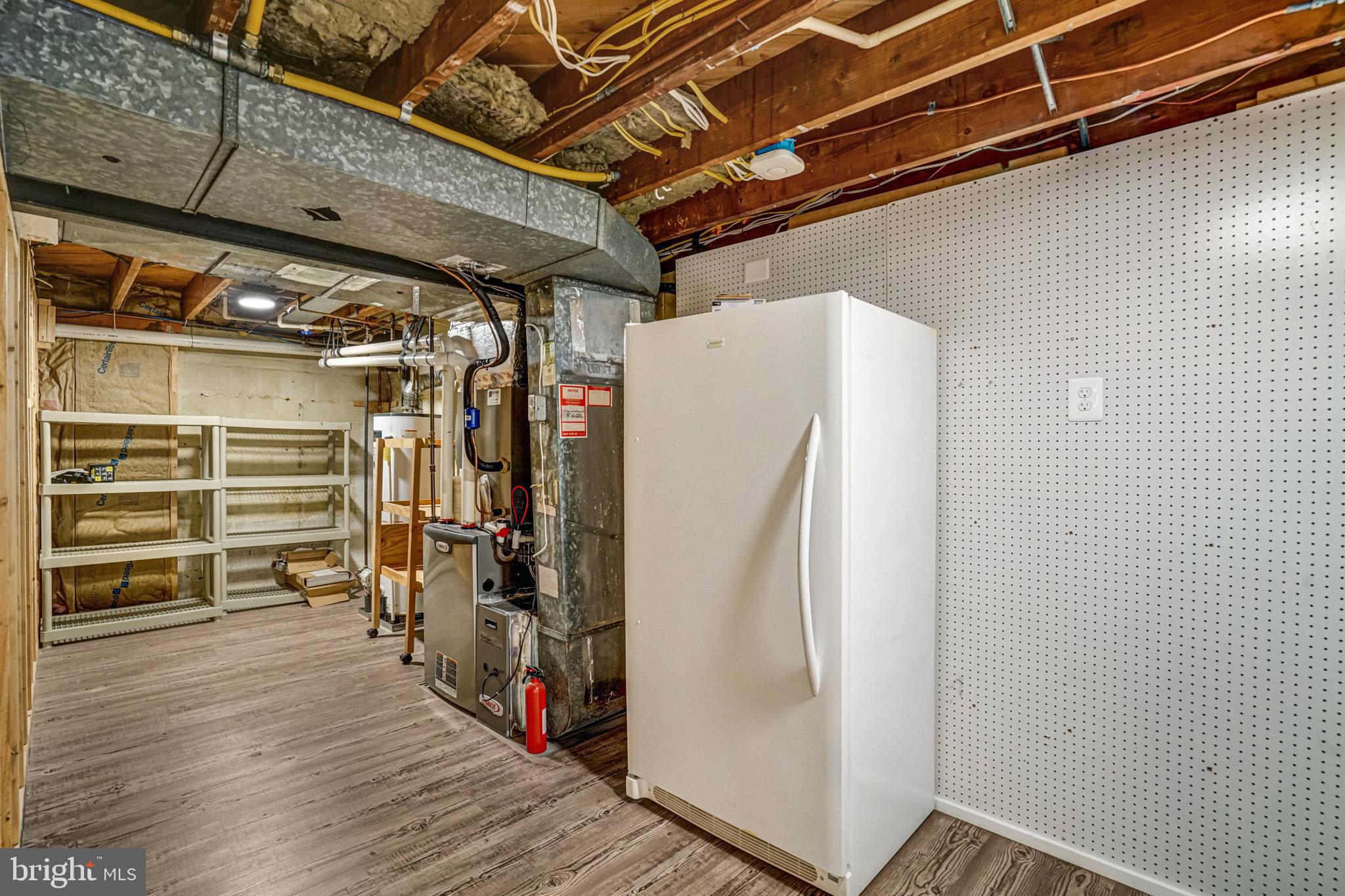 5227 Cather Road Springfield, VA 22151 - Photo 51 of 72 a view of a storage room with wooden floor