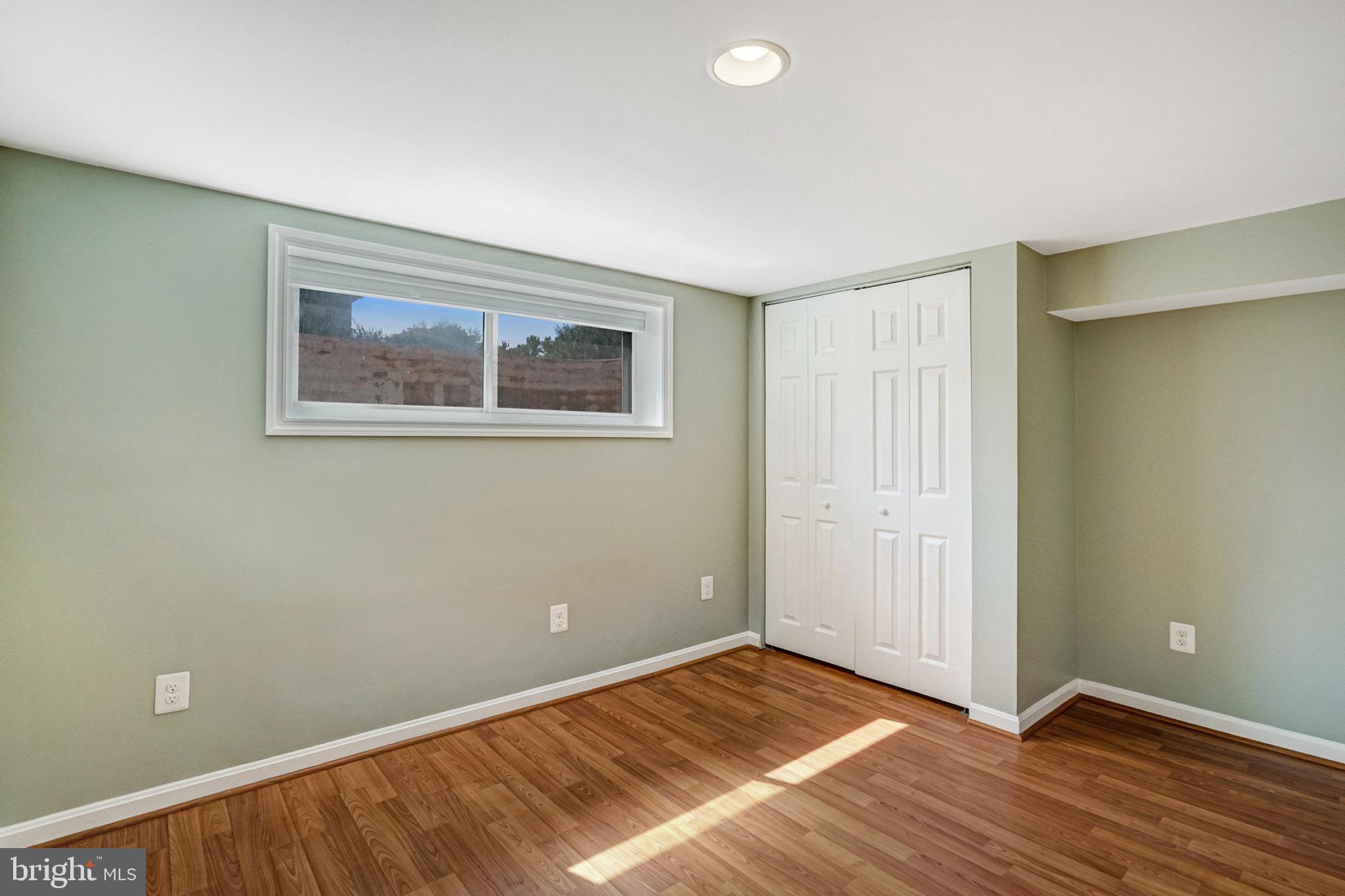 5227 Cather Road Springfield, VA 22151 - Photo 53 of 72 a view of an empty room with wooden floor and a window