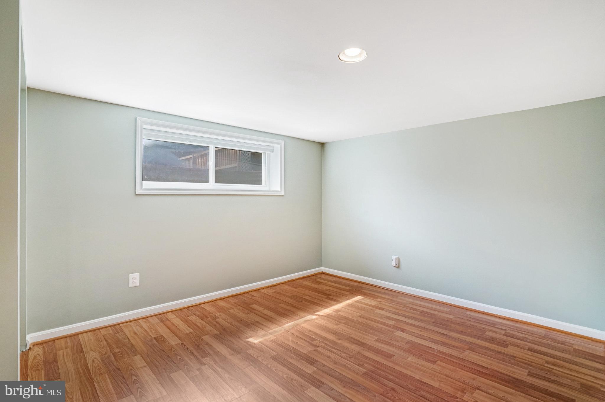 5227 Cather Road Springfield, VA 22151 - Photo 54 of 72 a view of empty room with wooden floor